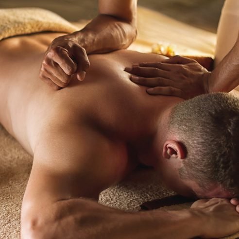 A man getting a back massage at a spa.