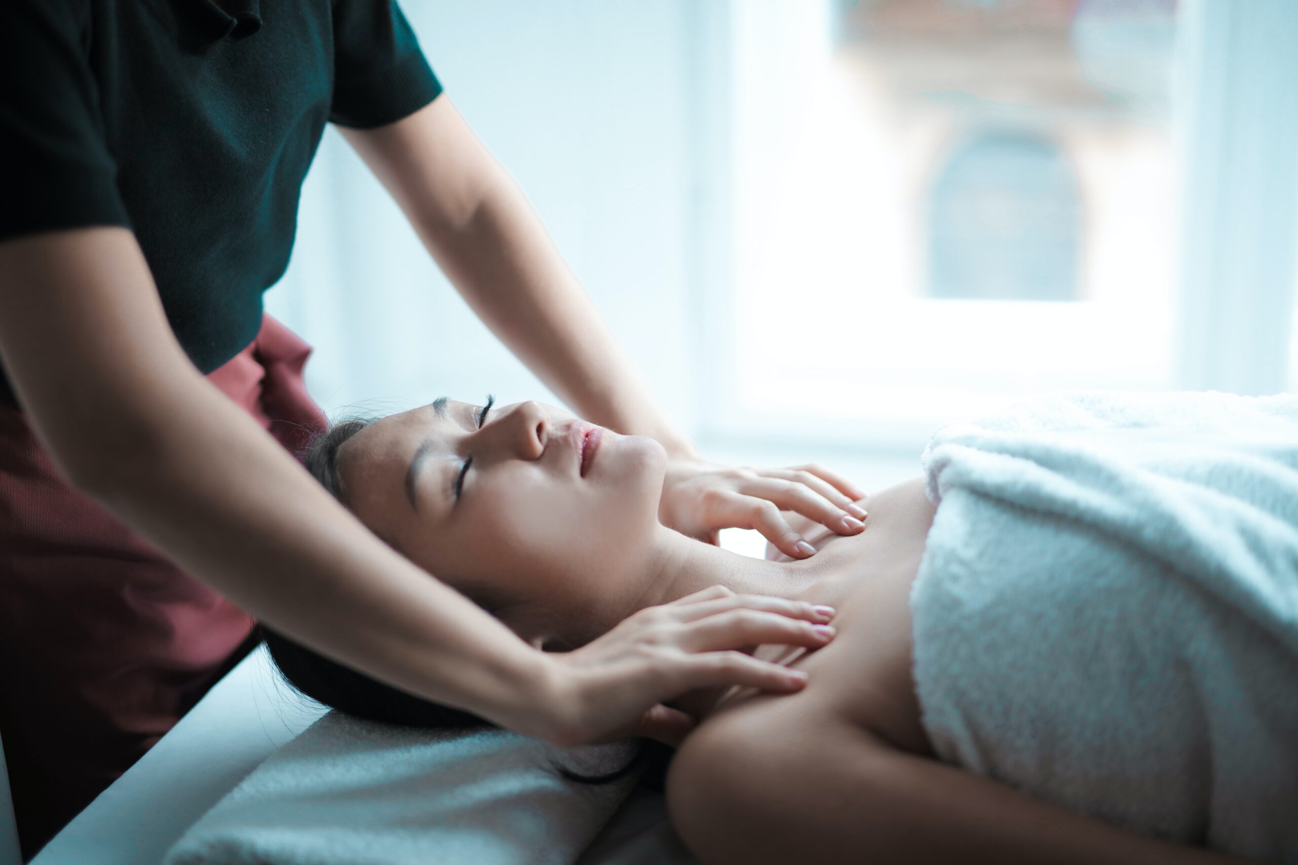 A woman getting a massage at a spa.