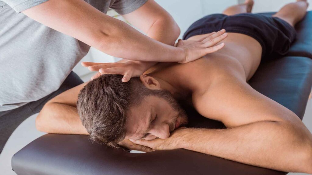 A man getting a back massage at a spa.