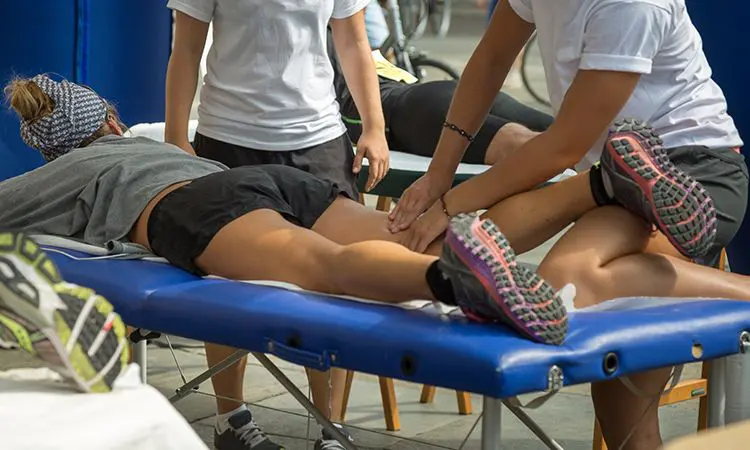 A woman receiving a sports massage at a gym.