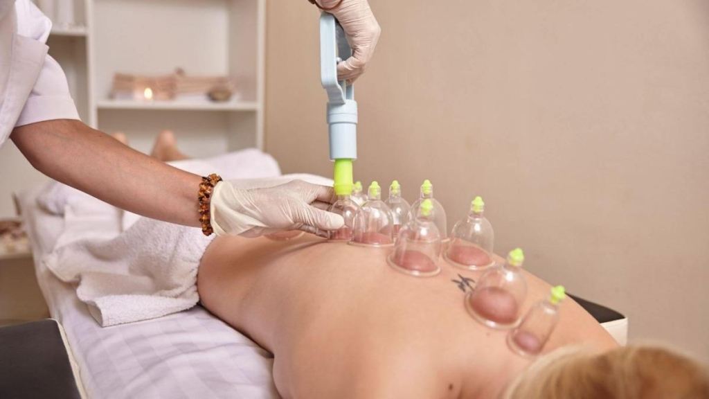 A woman is getting a massage with a bottle of water.